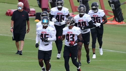 Taking the lead: Rookie Mykal Walker (43) and veteran Deion Jones are out front as the Falcons linebackers make their way to the next set of training camp drills.  Curtis Compton ccompton@ajc.com