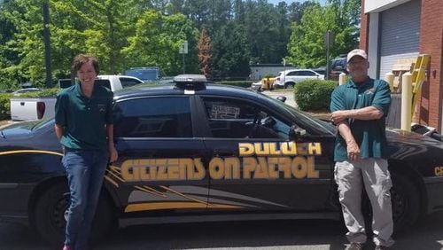 Two of Duluth’s first ‘Citizens on Patrol’ graduates stand with their specially marked car which will be used for patrol throughout the city. Courtesy Duluth Police Department