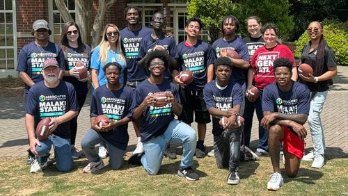 Malaki Starks (back row, fourth from left) poses with high school and middle school students who were treated to a tour of the University of Georgia's iconic North Campus and academic buildings on Saturday. They also got to participate in a makeshift football camp. (Photo provided by Kremer Communications)