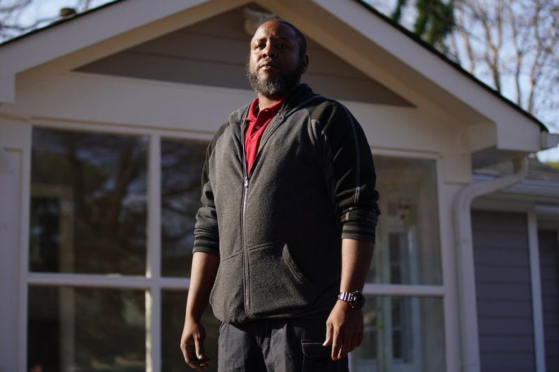 Sherrod Jefferson in front of a home he bought to remodel and resell in Atlanta. (Elijah Nouvelage/Special to the Atlanta Journal-Constitution)