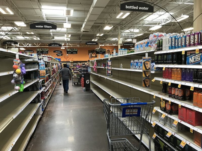 The bottled water aisle at the Kroger store on DeKalb Industrial Way and North Decatur Road was picked clean Wednesday. A massive water main break caused issues throughout DeKalb County. SHANE HARRISON / SHANE.HARRISON@AJC.COM