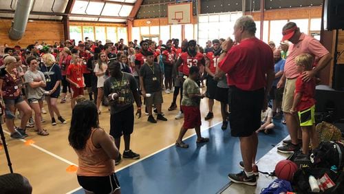 Camp Sunshine commander-in-chief Mo Thrash (with mic) introduces Georgia coach Kirby Smart (R) to campers and Georgia players during the Bulldogs' visit to the Camp Twin Lakes facility for critically-ill children in 2018. (Chip Towers/Chip.Towers@coxinccom)
