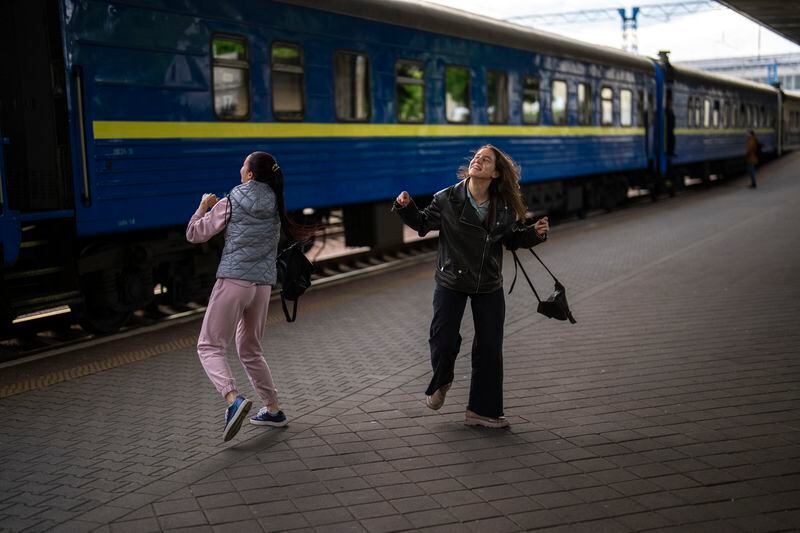 Two girls dance as Ukraine's song entrance in the Eurovision contest is played at the main train station, in Kyiv, Ukraine, Thursday, April 25, 2024. Ukraine’s entrants in the pan-continental music competition, the female duo of rapper alyona alyona and singer Jerry Heil set off from Kyiv for the competition on Thursday. In wartime, that means a long train journey to Poland, from where they will travel on to next month’s competition in Malmö, Sweden. (AP Photo/Francisco Seco)