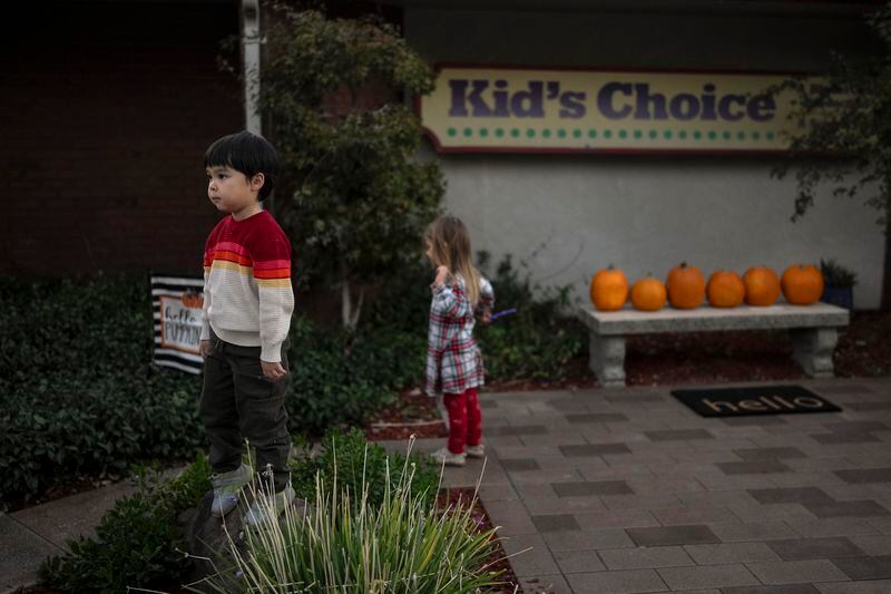 Ethan Quinn, 4, stands on a rock while playing with his classmates outside his daycare center in Concord, Calif., Wednesday, Nov. 1, 2023. Ethan's parents are among those who have opted for a private daycare instead of “transitional kindergarten” — a program offered for free by California elementary schools for some 4-year-olds, expressing the half-day program and options for afterschool child care were limited and didn't work for two parents juggling hectic work schedules. (AP Photo/Jae C. Hong)