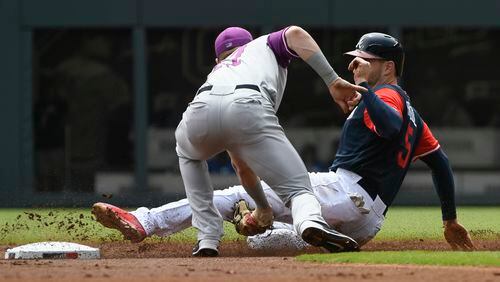 Atlanta Braves' Freddie Freeman, right, is caught stealing second base by Colorado Rockies shortstop Trevor Story during the first inning of a baseball game, Sunday, Aug. 27, 2017, in Atlanta. (AP Photo/John Amis)