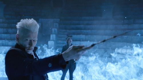 From left, Johnny Depp as Grindelwald and Poppy Corby-Tuech as Rosier in “Fantastic Beasts: The Crimes of Grindelwald.” Contributed by Warner Bros. Pictures