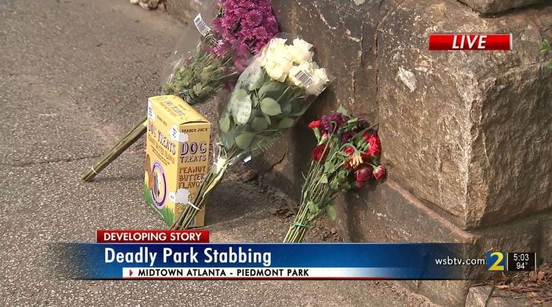 Flowers and dog treats were left at the entrance of Piedmont Park on Wednesday after a 40-year-old woman and her dog were killed overnight.