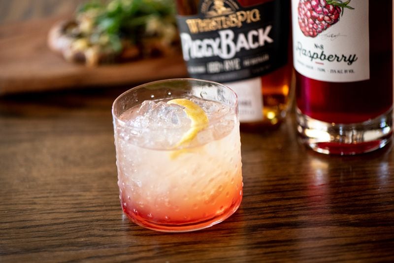 Bar (n) Booze (n) Bites Dunwoody ATM cocktail with WhistlePig 6 Year Piggyback Rye, Blended Family No. 8 Raspberry Liqueur, and lemon.  (Mia Yakel for The Atlanta Journal-Constitution)