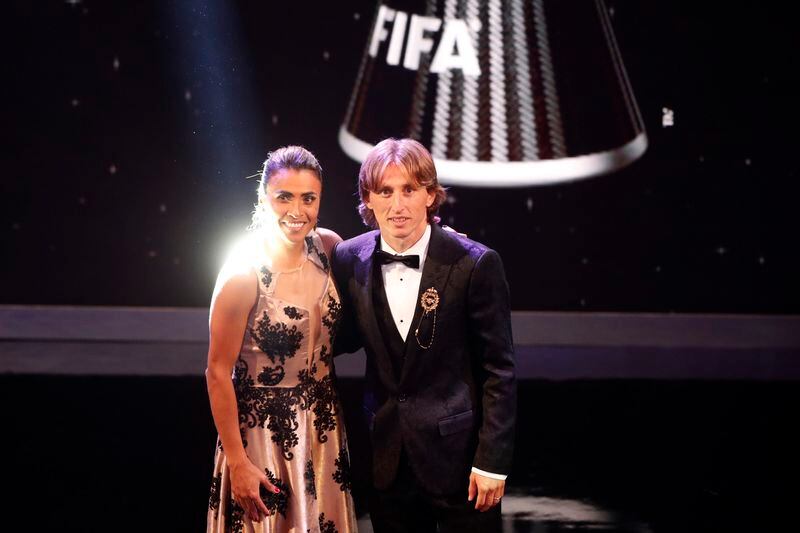 FILE - Brazil's soccer player Marta, left, who received the Best FIFA Women's Player award, poses for photos with Croatia's Luka Modric, who received the Best FIFA Men's Player award, during the Best FIFA Football Awards ceremony at Royal Festival Hall in London, Britain, Sept. 24, 2018. Marta, the six-time women's world player of the year, plans to retire from the national team after 2024. (AP Photo/Frank Augstein, File)