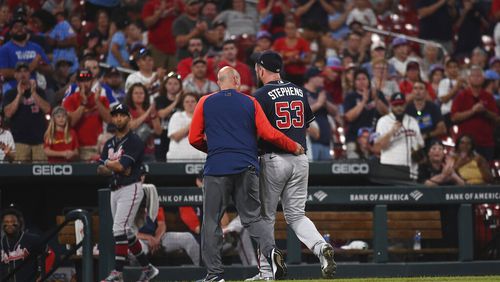 Atlanta Braves relief pitcher Jackson Stephens (53) is helped off the field by training staff after being hit by a line-drive by St. Louis Cardinals' Brendan Donovan (33) in the ninth inning of a baseball game against the Atlanta Braves on Friday, Aug. 26, 2022, in St. Louis. (AP Photo/Joe Puetz)