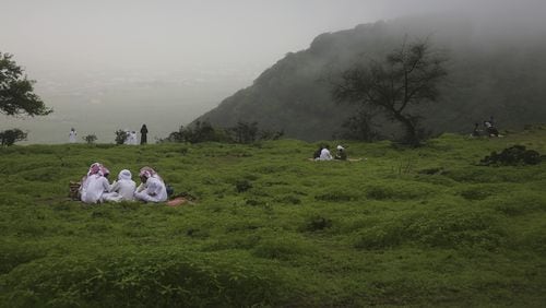 In this August 2, 2017 file photo, people picnic in the Jabal Ayoub mountains north of Salalah, Oman. The foggy monsoon season draws thousands of visitors seeking relief from high temperatures elsewhere in the Arab world. The season lasts three months, starting this year June 21. (AP Photo/Sam McNeil, File)