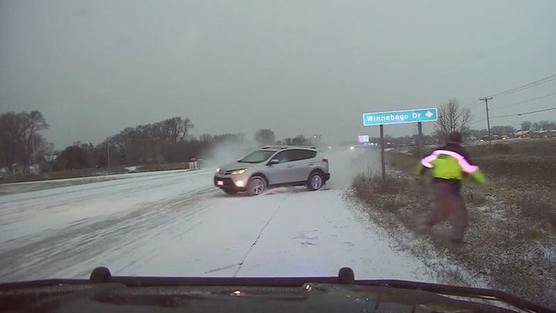A sheriff's deputy was nearly hit by a SUV after the driver lost control on snow-covered roads.
