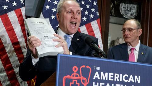 House Majority Whip Steve Scalise of La., left, joined by Rep. Phil Roe, R-Tenn., holds up a copy of the original Affordable Care Act bill during a news conference on Capitol Hill in Washington, Wednesday, March 8, 2017, as the GOP leadership talks about its work on the long-awaited Republican plan to repeal and replace "Obamacare." (AP Photo/J. Scott Applewhite)
