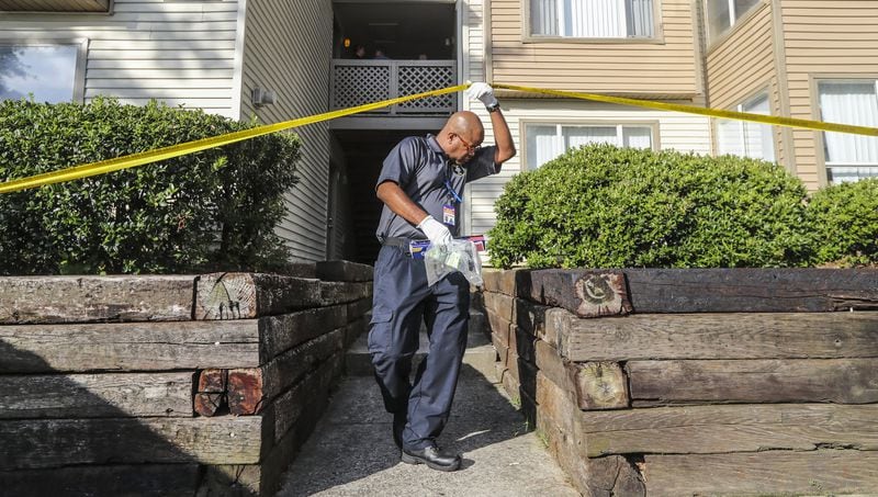 August 7, 2018 Gwinnett County: A Gwinnett County police crime scene specialist exits under the tape after collecting evidence. A woman was shot and killed in a domestic dispute at an apartment near Duluth Tuesday morning August 7, 2018, police said. The woman was found shot and taken to an area hospital, where she later died of her injuries. JOHN SPINK/JSPINK@AJC.COM