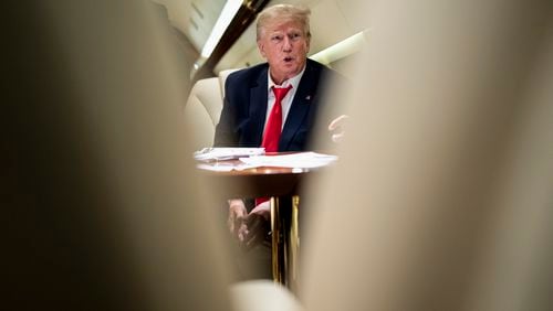 
                        FILE — Former President Donald Trump on his plane flying to Columbia, S.C., for a stop in his 2024 campaign, on Jan. 28, 2023. The indictment unveiled on Tuesday, Aug. 1, 2023, accused Trump of enlisting six co-conspirators in “his criminal efforts to overturn the legitimate results of the 2020 presidential election and retain power.” (Doug Mills/The New York Times)
                      