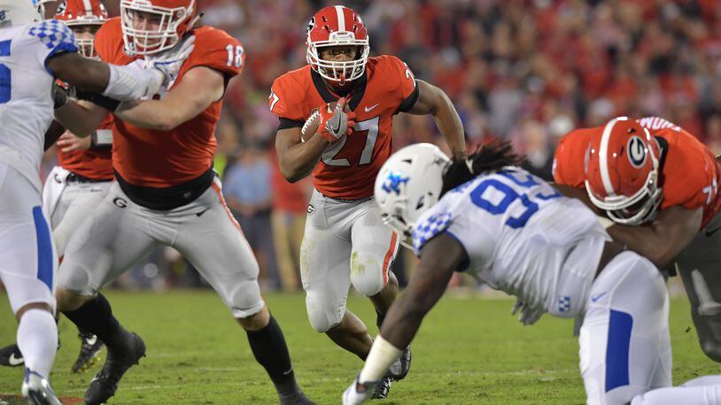 Georgia running back Nick Chubb (27) runs for a first down in the first half Saturday, Nov. 18, 2017, in  their 42-13 win over Kentucky.