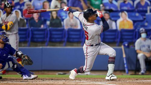Braves center fielder Cristian Pache follows through on a grand slam in front of Toronto Blue Jays catcher Alejandro Kirk during the second inning Saturday, May 1, 2021, in Dunedin, Fla. (Mike Carlson/AP)
