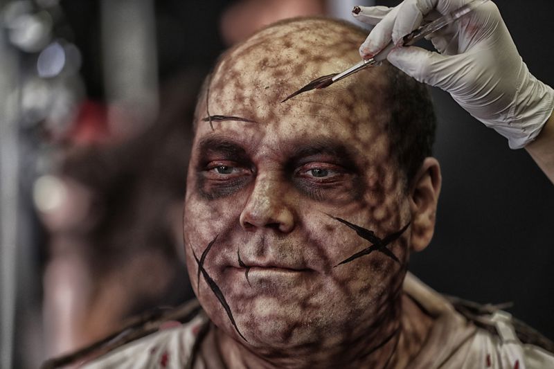 Actor Ed Cass who portrays Paul in the Saw House, receives final touches to his makeup backstage at Halloween Horror Nights at Universal Studios. (Robert Gauthier/Los Angeles Times/TNS)