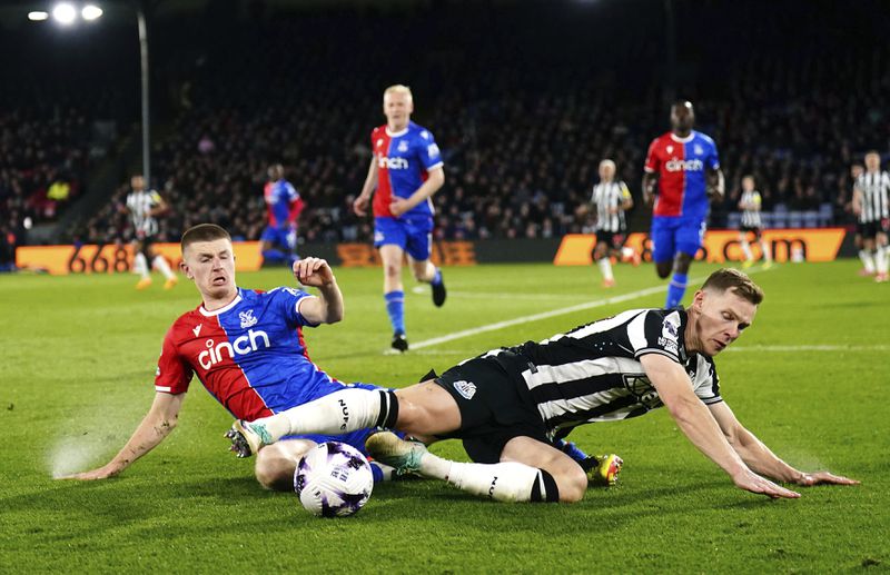 Crystal Palace's Adam Wharton, left and Newcastle United's Emil Krafth vie for the ball during the English Premier League soccer match between Crystal Palace and Newcastle United, at Selhurst Park, London, Wednesday April 24, 2024. (John Walton/PA via AP)