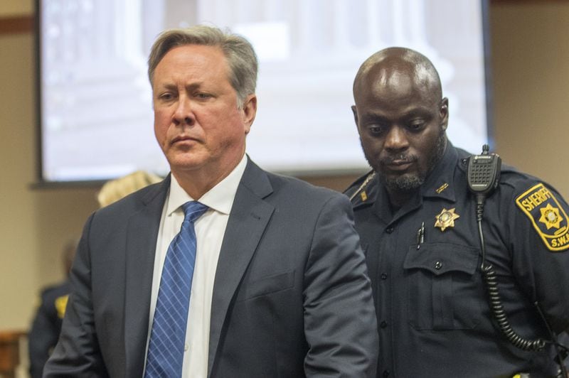 10/14/2019 — Decatur, Georgia — Robert “Chip” Olsen is escorted out of the courtroom after being found not guilty of felony murder for his trial in front of DeKalb County Superior Court Judge LaTisha Dear Jackson at the DeKalb County Courthouse in Decatur, Monday, October 14, 2019. The jury did reach guilty verdicts on four lesser charges: two counts of violation of oath of office, aggravated assault and making a false statement. (Alyssa Pointer/Atlanta Journal Constitution)
