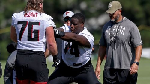 Falcons offensive tackle Germain Ifedi (74) does a drill with offensive tackle Kaleb McGary (76). Also pictured is offensive line coach Dwayne Ledford. (Jason Getz / Jason.Getz@ajc.com)