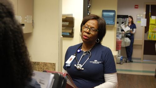 Velma Blackwell, a nurse at Northside Hospital Cherokee, checks in with her nursing team before starting rounds. Blackwell, 71, was the first African-American allowed to work as a nurse at the hospital. CONTRIBUTED
