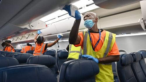 July 22, 2020 Atlanta - Cleaning crew thoroughly wipe down aircraft cabin on Concourse A at Hartsfield-Jackson International Airport on Wednesday, July 22, 2020. (Hyosub Shin / Hyosub.Shin@ajc.com)