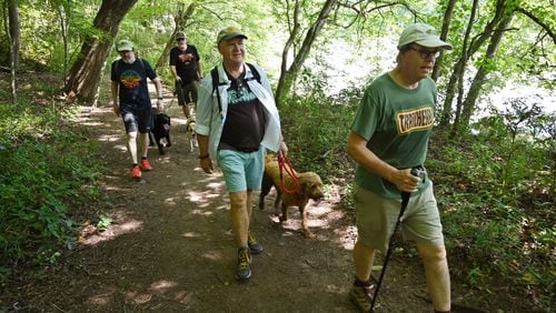 Members of the Trailheads (from left) George Hirthler, Brad Copeland with his dogs Elvis and Nilla, Guy Tucker with his dog Fio, and Patrick Scullin hike at Island Ford Park along the Chattahoochee River. (Hyosub Shin / Hyosub.Shin@ajc.com)