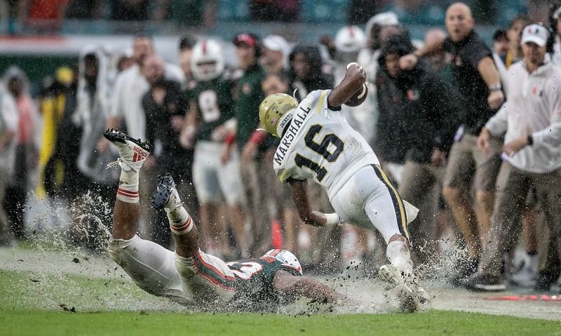 Georgia Tech Yellow Jackets quarterback TaQuon Marshall (16) is chased out of bounds by Miami Hurricanes defensive lineman Trent Harris (33) Oct. 14, 2017, at Hard Rock Stadium in Miami Gardens, Fla. 