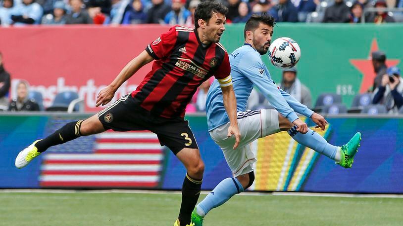 Atlanta United defender Michael Parkhurst (3) and New York City FC forward David Villa (7), of Spain, go for the ball during the first half of a Major League Soccer game Sunday, May 7, 2017, in New York. (AP Photo/Kathy Willens)