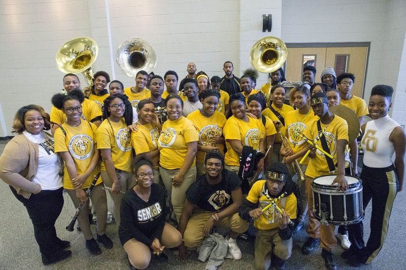 Members of the Frederick Douglass High School marching band pose for a photo after practice at the school. ALYSSA POINTER/ALYSSA.POINTER@AJC.COM