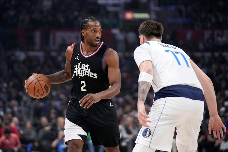 Los Angeles Clippers forward Kawhi Leonard, left, looks to pass while under pressure from Dallas Mavericks guard Luka Doncic during the first half in Game 2 of an NBA basketball first-round playoff series Tuesday, April 23, 2024, in Los Angeles. (AP Photo/Mark J. Terrill)