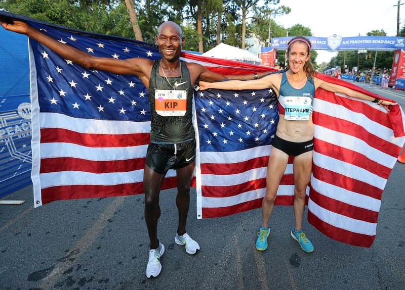 In this file photo, Bernard Kip Lagat and Stephane Bruce celebrate winning the AJC Peachtree Road Race on July 4, 2018, in Atlanta.     Curtis Compton/ccompton@ajc.com