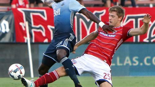 FC Dallas' Walker Zimmerman (25) stretches to steal the ball from Vancouver Whitecaps' Bernie Ibini-lsei (23) during the first half of an MLS soccer match in Frisco, Texas, Saturday, July 29, 2017. (Steve Hamm/The Dallas Morning News via AP)