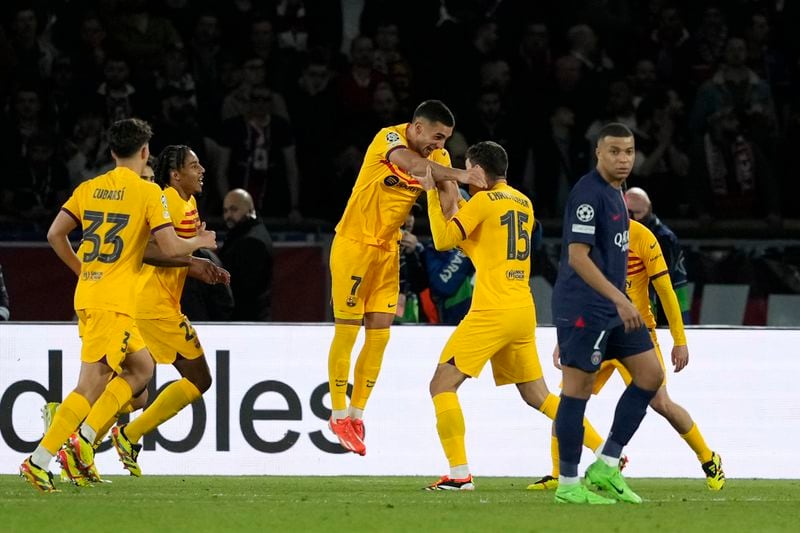 Barcelona's Andreas Christensen, center, right, celebrates after scoring his side's third goal during the Champions League quarterfinal first leg soccer match between Paris Saint-Germain and Barcelona at the Parc des Princes stadium in Paris, Wednesday, April 10, 2024. (AP Photo/Lewis Joly)