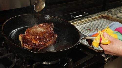 The steak cooks low and slow, at 225 degrees, in the oven until the middle reaches 110 degrees. Then it's browned in a hot skillet, while being basted with butter to help promote the browning. (Chris Walker/Chicago Tribune/TNS)