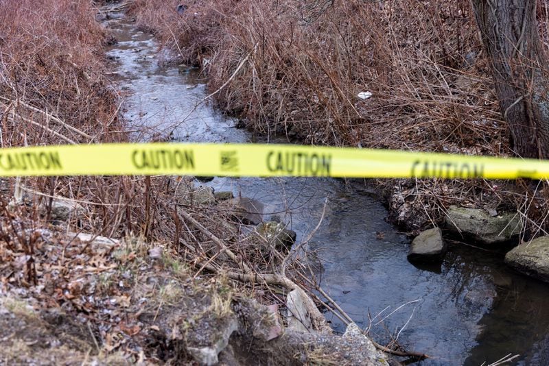 Caution tape is seen over polluted water in East Palestine, Ohio on Friday, February 17, 2023.  (Arvin Temkar / arvin.temkar@ajc.com)
