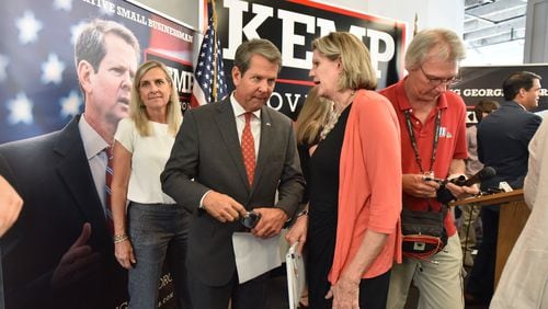 September 19, 2018 Atlanta - Republican nominee for Governor, Brian Kemp, talks with Georgia House Speaker Pro-Tem, Rep. Jan Jones after a press conference to unveil school safety plan at Brian Kemp campaign headquarters in Buckhead on Wednesday, September 19, 2018.  HYOSUB SHIN / HSHIN@AJC.COM
