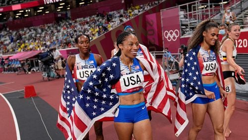 USA's Allyson Felix, middle, joins teammates Athing Mu, Dalilah Muhammad and Sydney Mclaughlin in celebrating victory in the Women's 4x400m Relay Final during the Tokyo 2020 Olympic Games at the Olympic Stadium in Tokyo on Saturday, Aug. 7, 2021. (David J. Phillip/POOL/AFP/Getty Images/TNS)