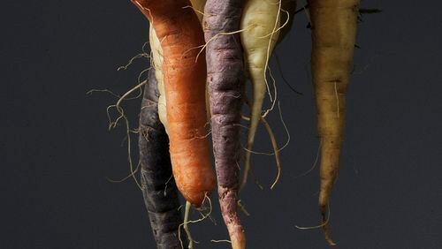 Intertwined carrots in a variety of colors are considered "imperfect" by most consumers. (Eric Paul Zamora/Fresno Bee/TNS)