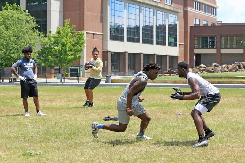 (Left to right) Randy Britt, Kaece Supples, Keeman Hayes and Travis Davis run one-on-ones during an unsanctioned player-led football practice on Thursday, June 4, 2020, at Tucker High School in Tucker, Georgia. The players planned the off-season practice despite uncertainty surrounding the upcoming football season amid coronavirus concerns. CHRISTINA MATACOTTA FOR THE ATLANTA JOURNAL-CONSTITUTION