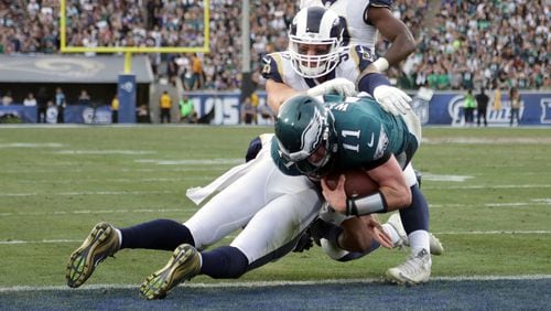 Philadelphia quarterback Carson Wentz is hit by Mark Barron during the third quarter. Wentz was later escorted off the field due to a knee injury Sunday, Dec. 10, 2017, at the Los Angeles Memorial Coliseum in Los Angeles.