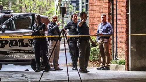 Investigators collect evidence at the scene of a homicide Monday morning at a Dunwoody apartment complex near Perimeter Mall.