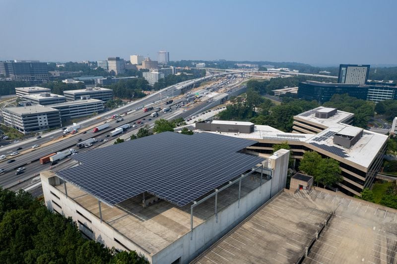 Solar panels atop a parking garage and on building rooftops at the Palisades office complex in Atlanta on Tuesday, July 18, 2023.   (Ben Gray / Ben@BenGray.com)
