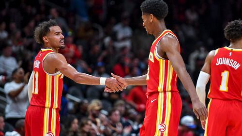 Atlanta Hawks guard Trae Young (11) congratulates forward De’Andre Hunter (12) after scoring in the second half of an NBA game Monday, October 30, 2023 at State Farm Arena. (Daniel Varnado/For the AJC)