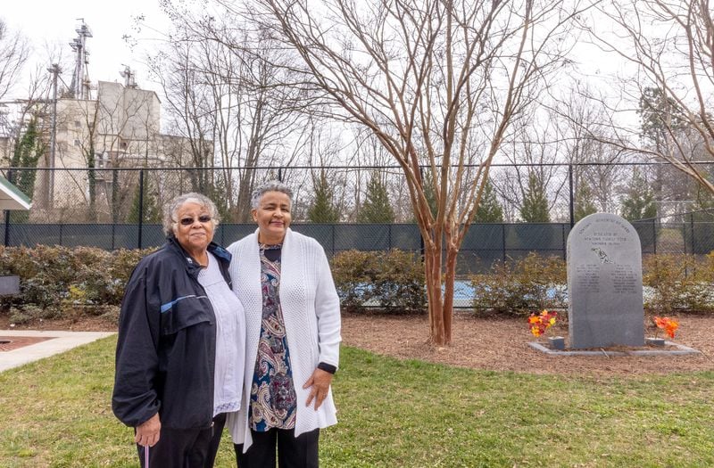 Newton Florist Club members Delinda Luster, left, and Rose Johnson visit the memorial created in 1994 to remember a few of the many residents who have died of cancer or lupus in their Gainesville community. (Jenni Girtman for The Atlanta Journal-Constitution)