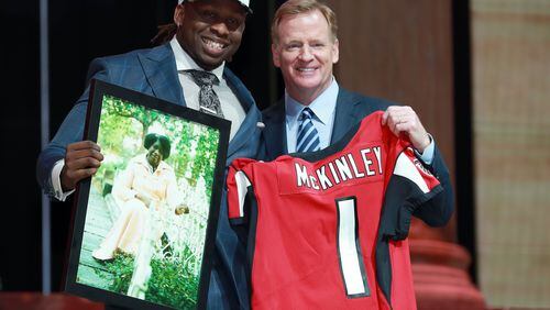 UCLA’s Takkarist McKinley poses with NFL commissioner Roger Goodell after being selected by the Falcons during the first round of the NFL draft Thursday night. (Jeff Haynes/AP)