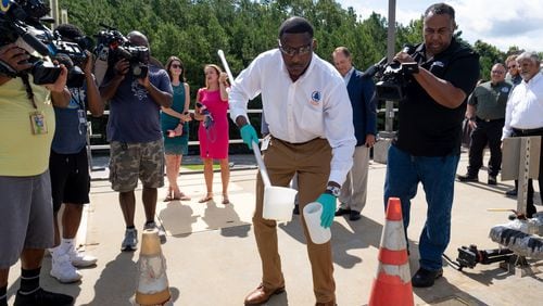 Fulton County Lab Manager Patrick Person takes a sample of sewage at the Camp Creek Water Reclamation Facility on Tuesday morning, July 26, 2022. The sample is used to test for COVID-19 and monkeypox infections in the community. (Ben Gray for the Atlanta Journal-Constitution)