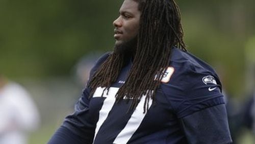 Seattle Seahawks guard James Carpenter stands on the sidelines during a practice drill, Tuesday, May 28, 2013, at an NFL football organized team activity in Renton, Wash. (AP Photo/Ted S. Warren)