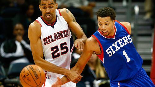 ATLANTA, GA - DECEMBER 10: Thabo Sefolosha #25 of the Atlanta Hawks and Michael Carter-Williams #1 of the Philadelphia 76ers battle for a loose ball at Philips Arena on December 10, 2014 in Atlanta, Georgia. NOTE TO USER: User expressly acknowledges and agrees that, by downloading and or using this photograph, User is consenting to the terms and conditions of the Getty Images License Agreement. (Photo by Kevin C. Cox/Getty Images)